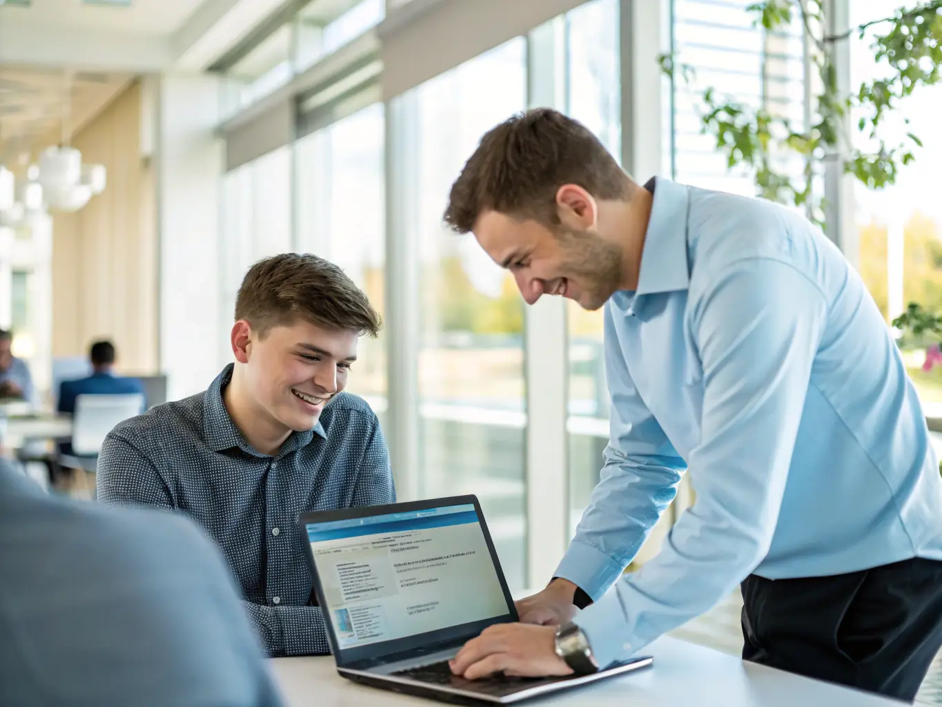 A friendly IT support professional assisting an office worker at their desk, with visible software troubleshooting on the computer screen, symbolizing responsive software and user support.